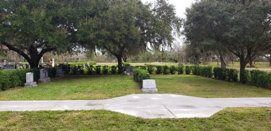 The newly expanded section of Jerusalem Gardens at Venice Memorial Gardens, bordered by hedges beneath mature trees
