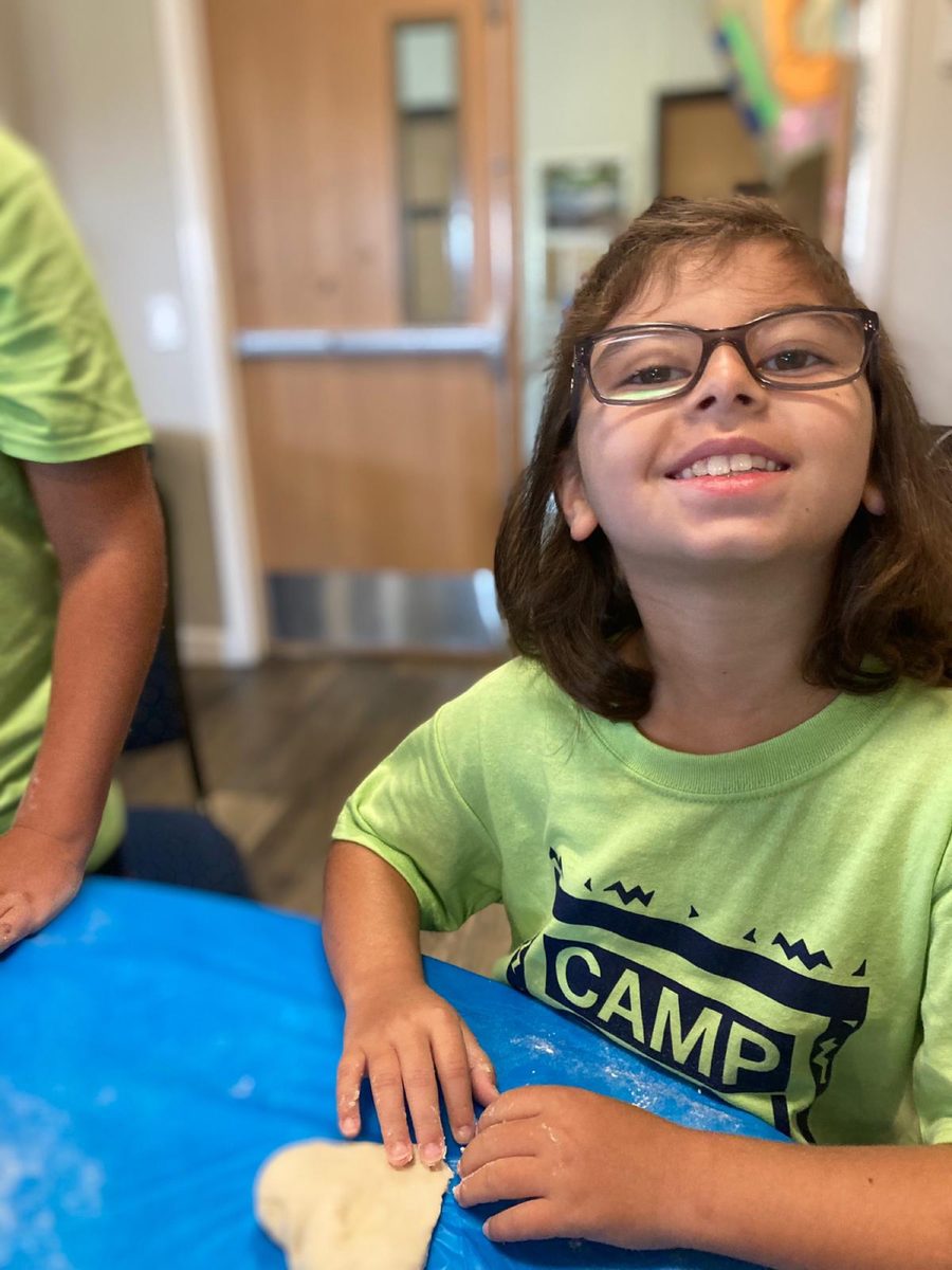 A smiling camper in a Camp Gan Israel shirt