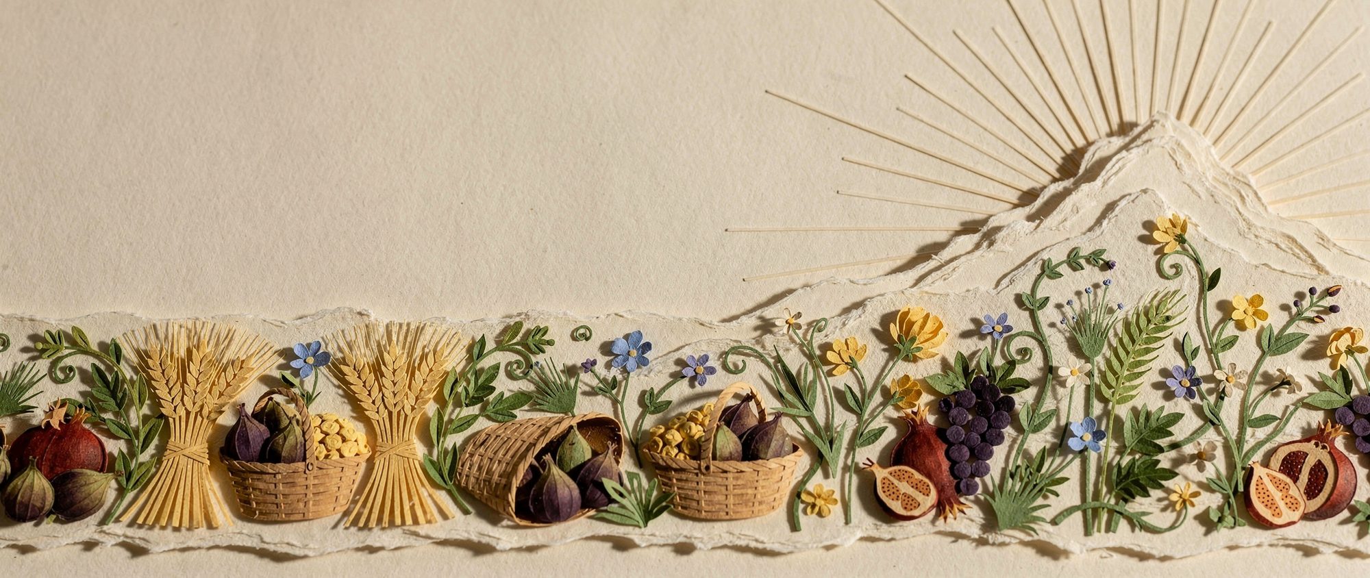 Papercut frieze of first-fruit baskets and wheat below Sinai