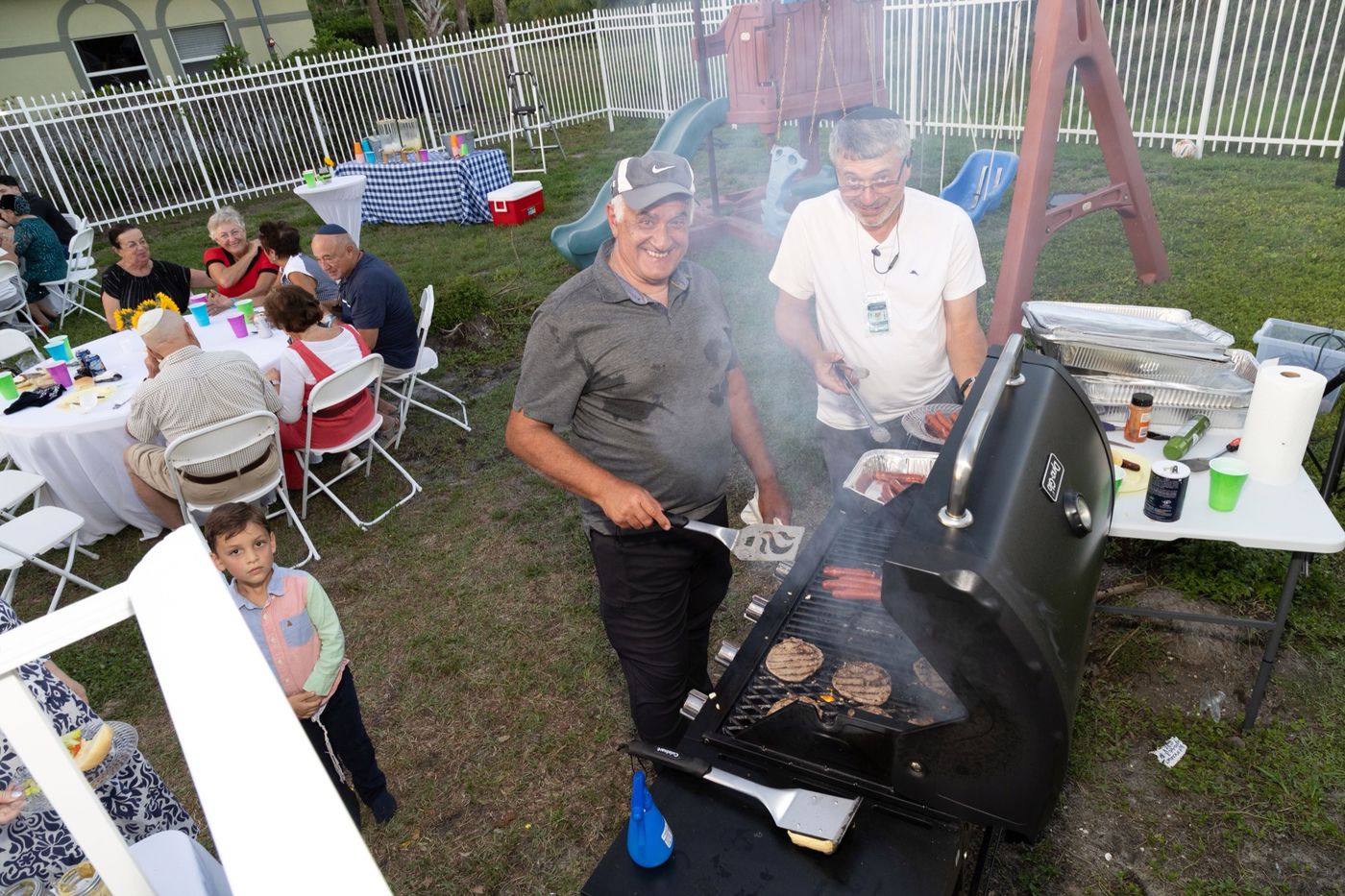 Grilling burgers at the Lag BaOmer BBQ