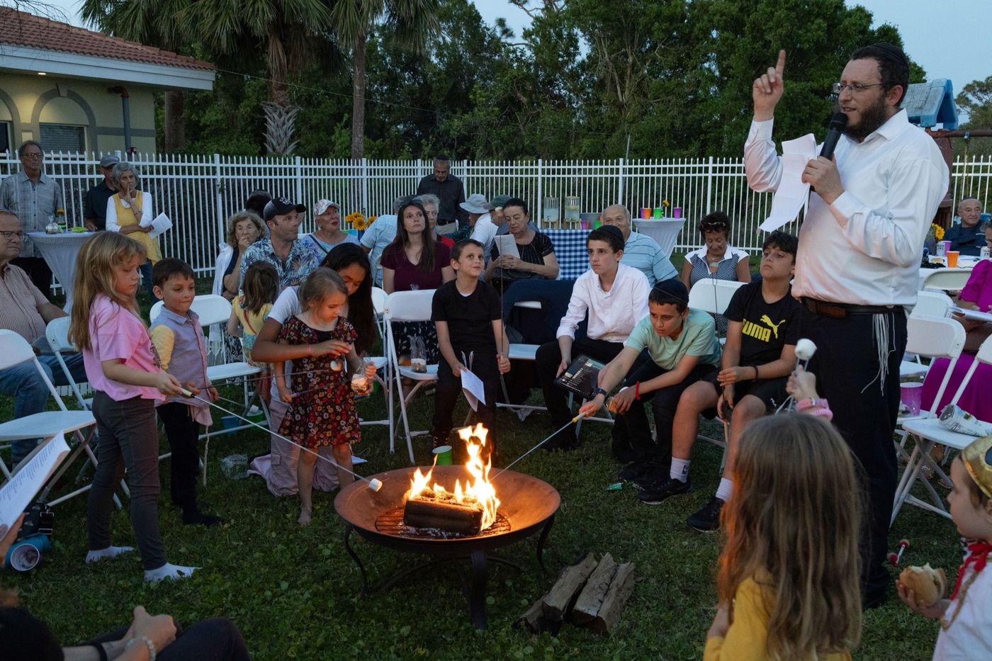 Children roasting marshmallows at the fire