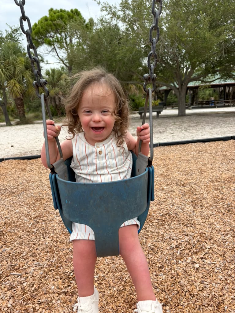 Yisroel Schmerling laughing on a swing